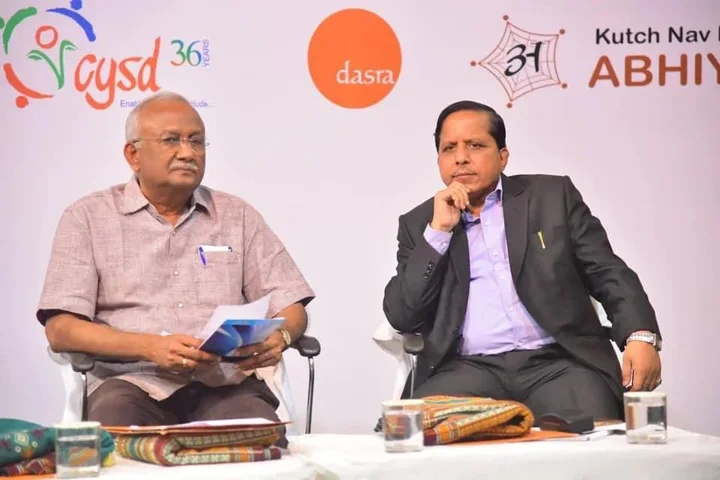 Pradeep Biswal seated in conversation at a public event