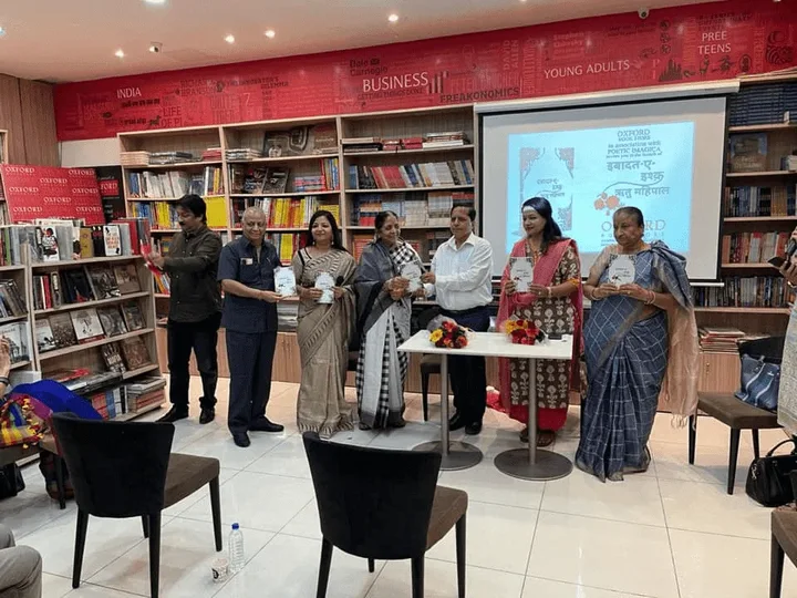 Participants standing beside a presentation screen at a bookshop gathering